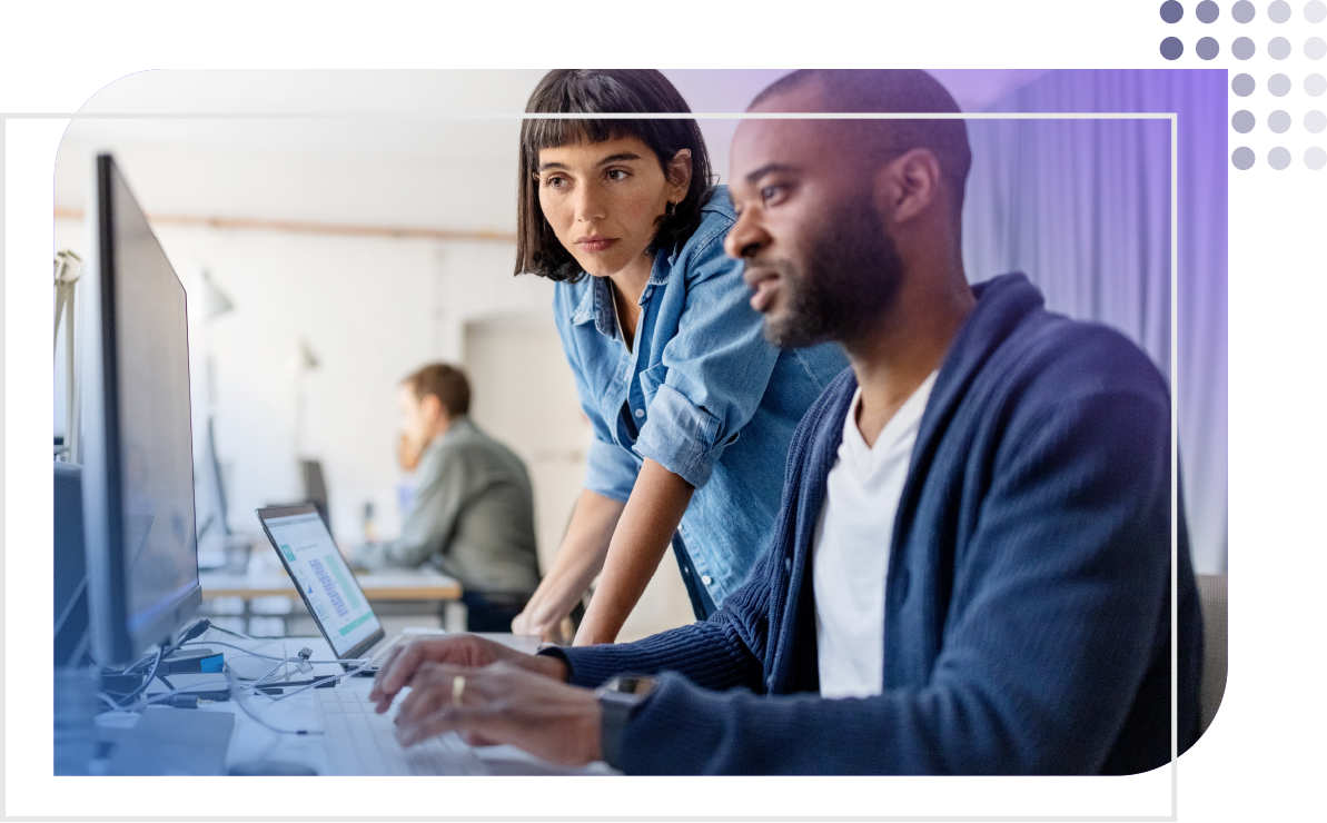 female and male coworker reviewing numbers on a computer