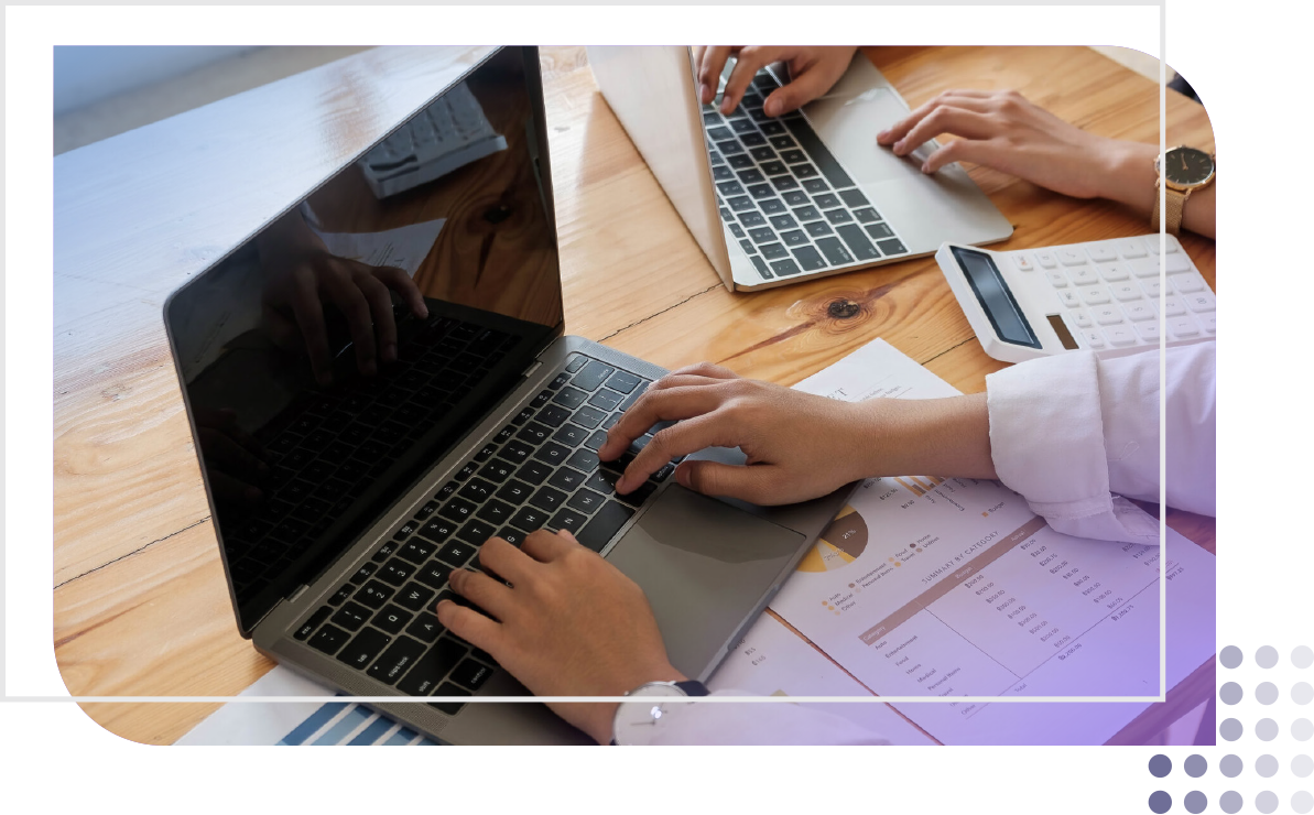 two coworkers working on their laptop