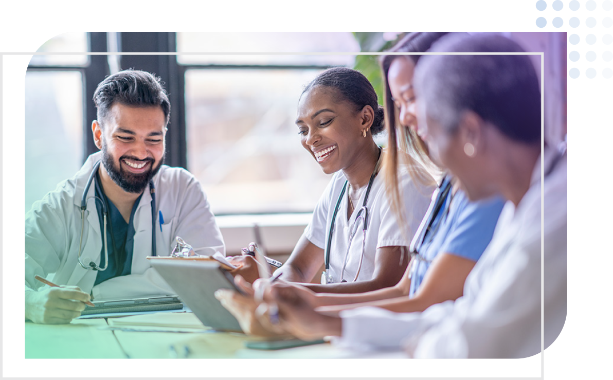 a male doctor meeting with a group of nurses